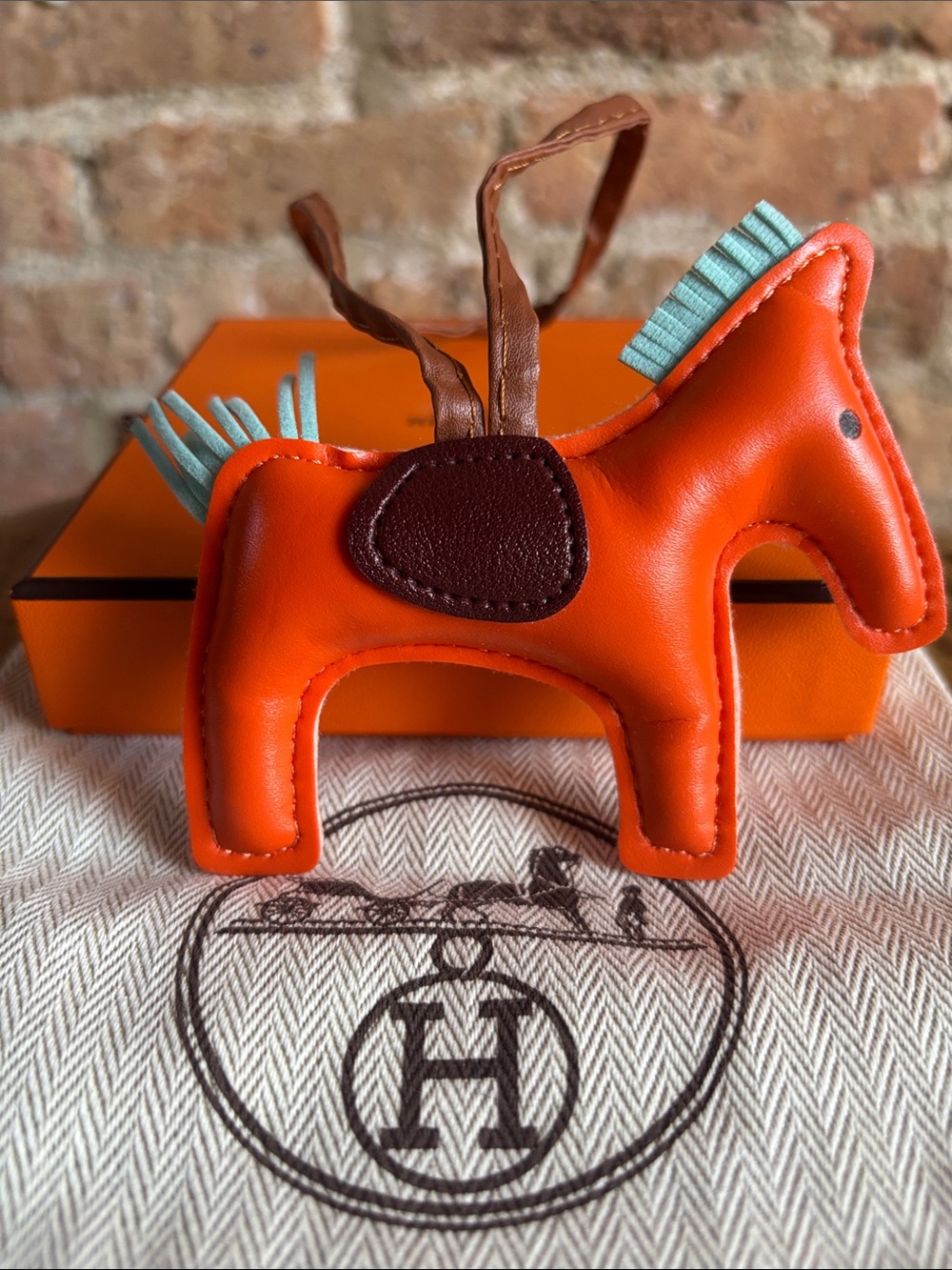 HERMES Classic Orange Leather Horse Bag Charm.